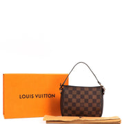 Buy an authentic second-hand Damier Ebene Canvas Mini Pochette Accessoires Top Handle Bag in very good condition at Labellov in Antwerp.