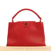Shop safe online at Labellov in Antwerp, Brussels and Knokke this 100% authentic second hand Louis Vuitton Rubis Taurillon Leather Capucines MM Top Handle