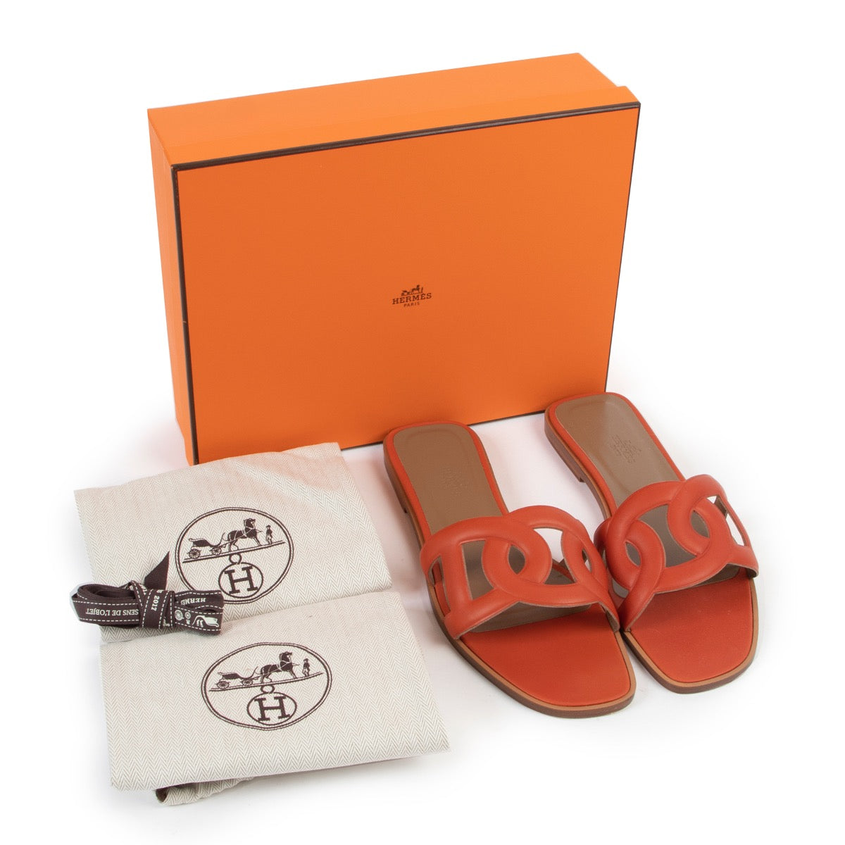 Buy an authentic pair of second hand Hermès Omaha orange sandals size 41 at Labellov