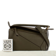 Shop safe online at Labellov in Antwerp and Knokke this 100% authentic second hand Loewe Khaki Calfskin Puzzle Edge Small Hand Bag