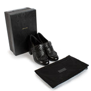 Unveil a blend of classic style and contemporary flair with the Dries Van Noten Black Croc-Printed Loafer Heels. In size 37, these sophisticated shoes feature a luxurious black croc-printed leather exterior that exudes elegance and uniqueness. The loafer-