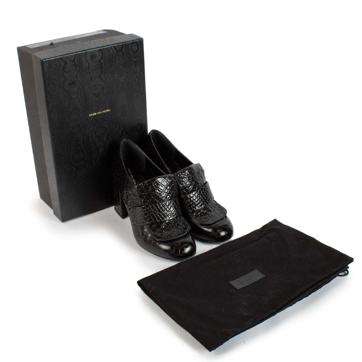 Unveil a blend of classic style and contemporary flair with the Dries Van Noten Black Croc-Printed Loafer Heels. In size 37, these sophisticated shoes feature a luxurious black croc-printed leather exterior that exudes elegance and uniqueness. The loafer-