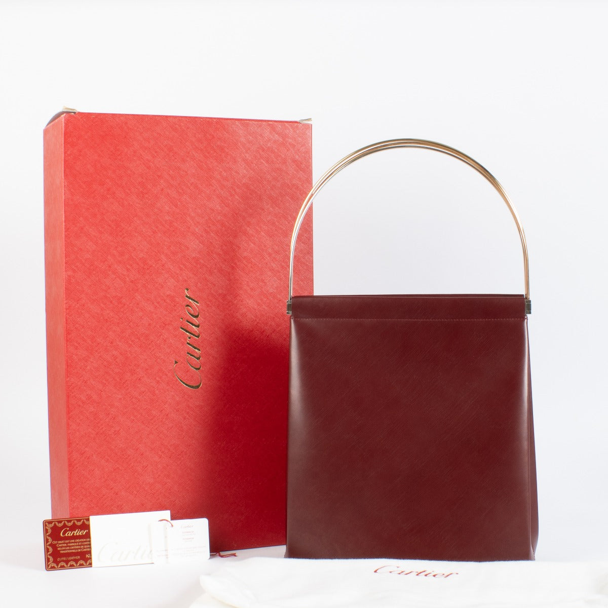 Authentic Cartier Burgundy Trinity Bag with gold handle at Labellov.com