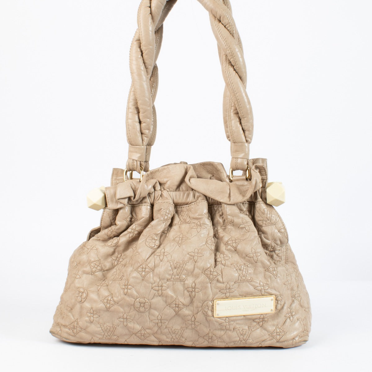 Shop the Louis Vuitton Olympe Stratus PM Bag in beige at Labellov. Crafted from soft monogram-embossed leather, this elegant pre-loved handbag features twisted handles, gold-tone details, and timeless Louis Vuitton craftsmanship. A chic and collectible pi