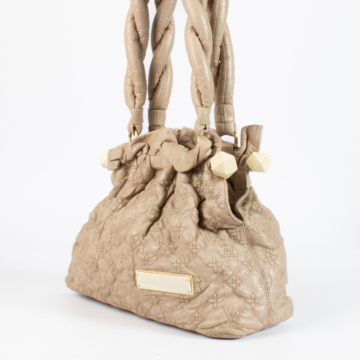 Shop the Louis Vuitton Olympe Stratus PM Bag in beige at Labellov. Crafted from soft monogram-embossed leather, this elegant pre-loved handbag features twisted handles, gold-tone details, and timeless Louis Vuitton craftsmanship. A chic and collectible pi