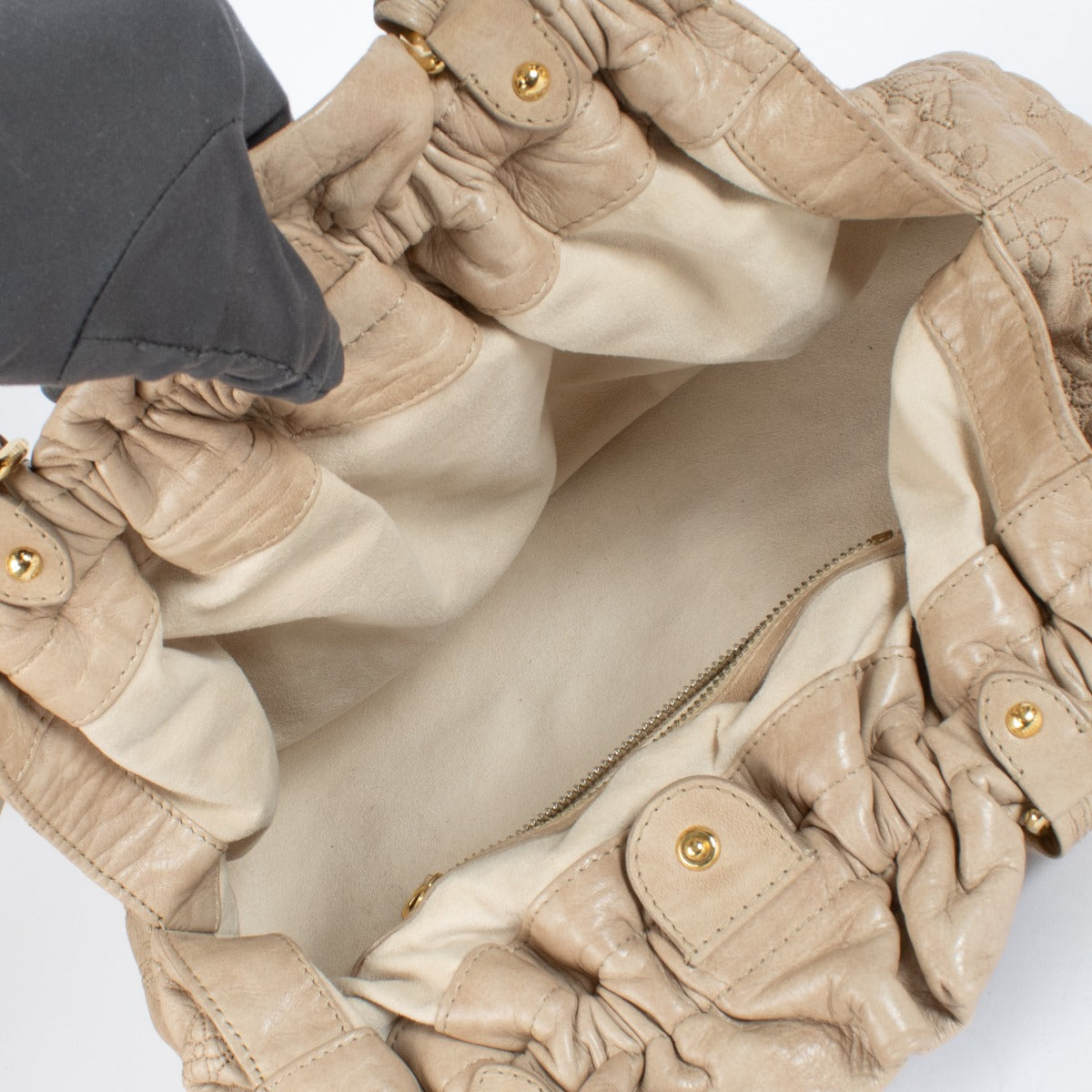 Shop the Louis Vuitton Olympe Stratus PM Bag in beige at Labellov. Crafted from soft monogram-embossed leather, this elegant pre-loved handbag features twisted handles, gold-tone details, and timeless Louis Vuitton craftsmanship. A chic and collectible pi