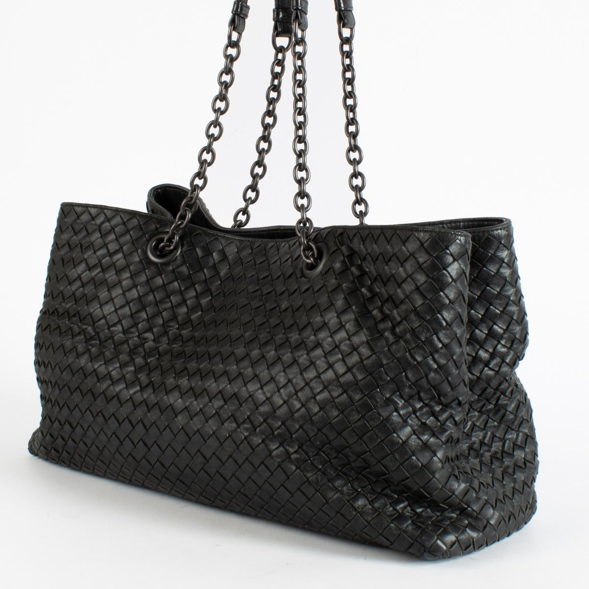 Black Bottega Veneta Intrecciato leather chain tote bag with woven design and spacious interior.