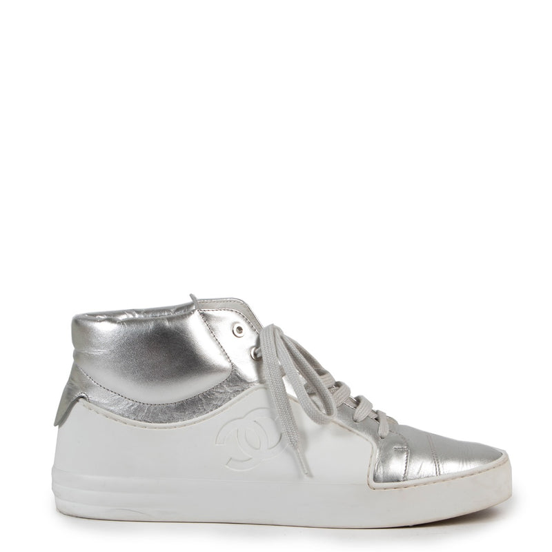 Shop online authentic Chanel White Silver High Top Sneakers in Size 38 at the right price.