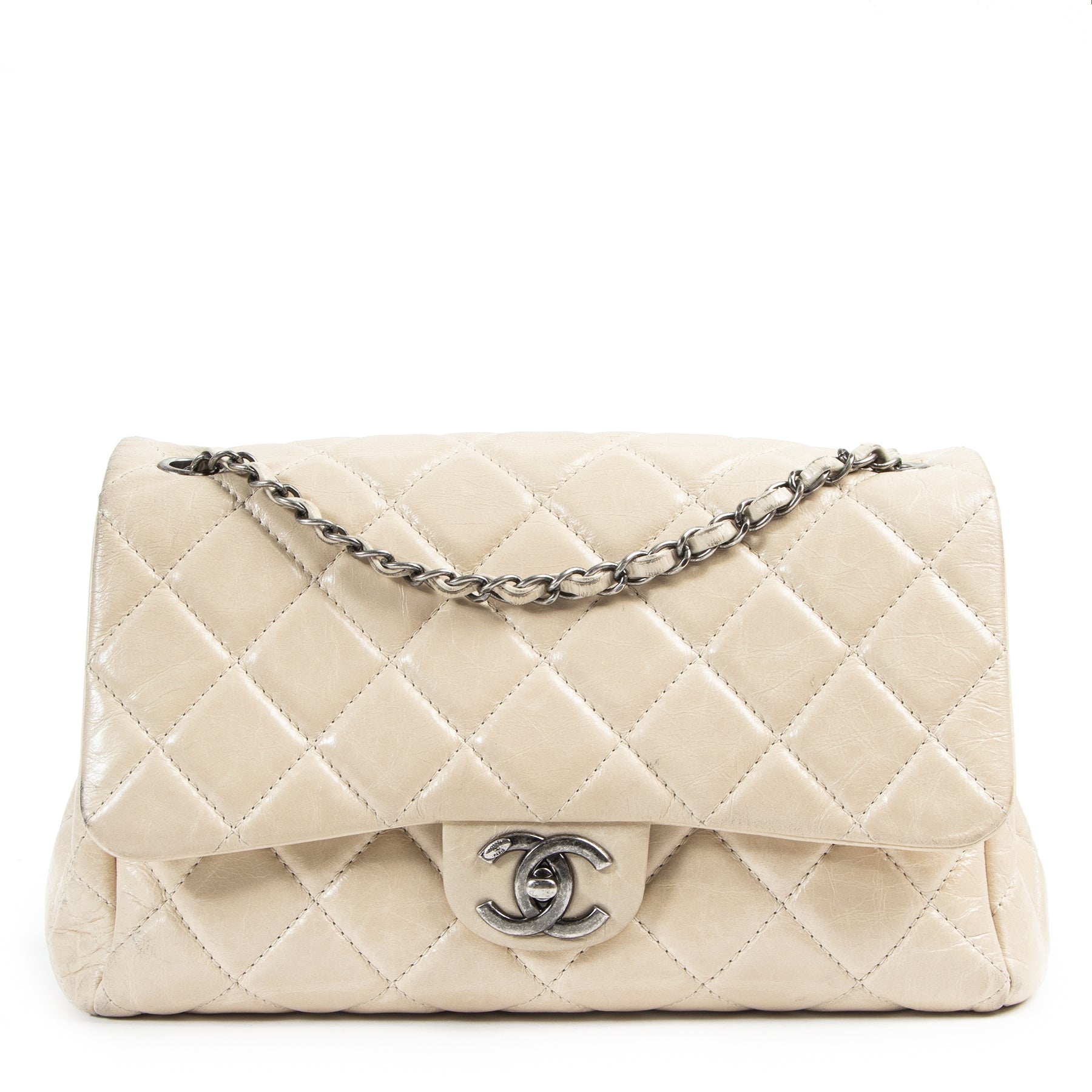 We buy and sell your authentic designer Chanel Cream Distressed Leather Flap Bag