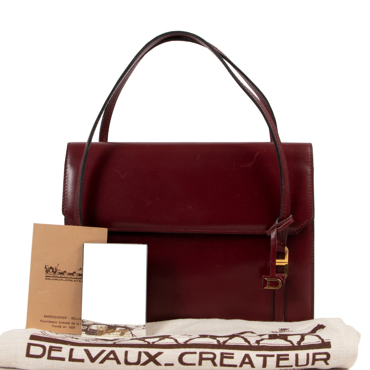 Available now at Labellov Delvaux Burgundy Top Handle for a reasonable price and in preloved condition. Buy vintage and secondhand delvaux bags