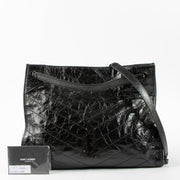 Shop this authentic luxury Saint Laurent All Black Vintage Calfksin Niki Small Shopping Bag Pre-Loved on Labellov.com