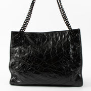 Shop this authentic luxury Saint Laurent All Black Vintage Calfksin Niki Small Shopping Bag Pre-Loved on Labellov.com