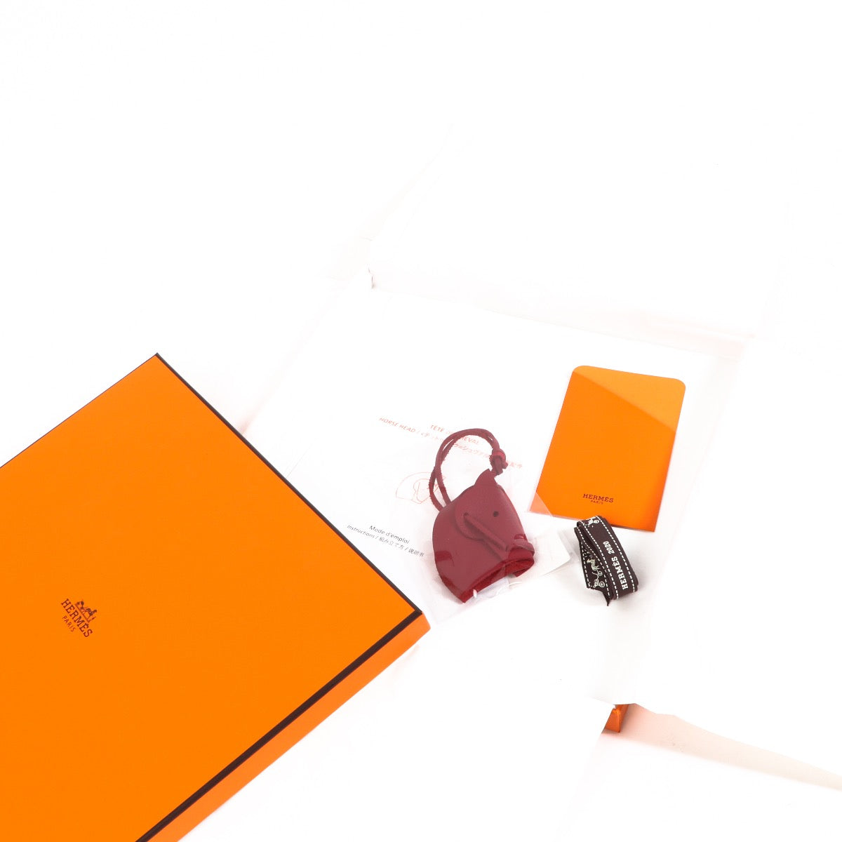 Buy an authentic Hermès Burgundy Tête De Cheval Bag Charm in as new condition at Labellov in Antwerp.