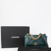 A modern icon reimagined in an opulent forest green hue, this Large Chanel 19 Flap Bag epitomizes contemporary elegance with timeless Chanel heritage. Introduced by Karl Lagerfeld and Virginie Viard, the Chanel 19 is celebrated for its effortlessly chic s