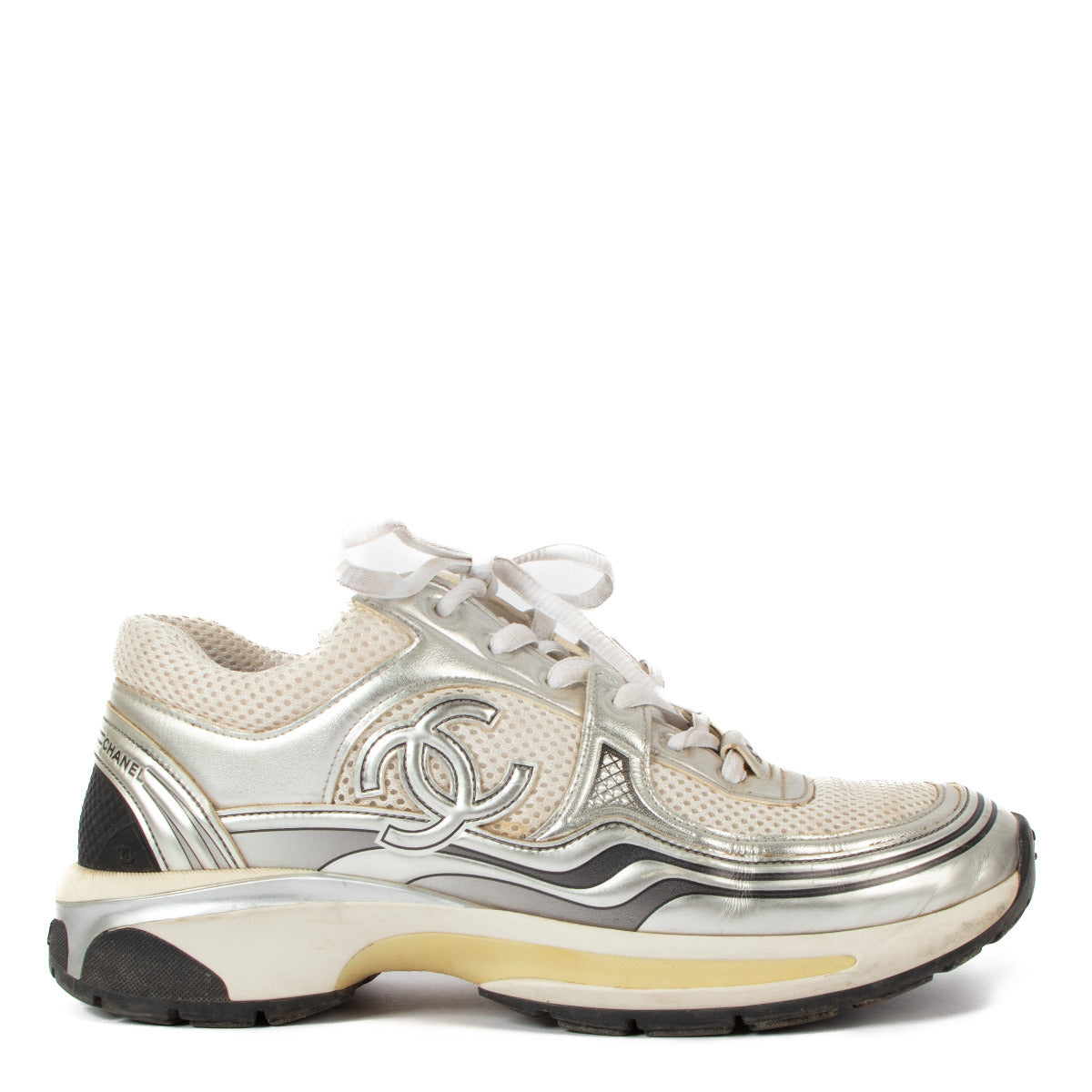 Chanel White Mesh Sneakers - size 39 These chic sneakers feature a modern design crafted from breathable white mesh, accented with subtle Chanel branding and silver metallic details for an effortlessly stylish look. Lightweight and versatile, they are