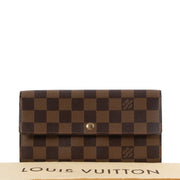 Buy online authentic second hand Louis Vuitton 2004 Vintage Damier Ebene Sarah Long Wallet in very good condition at Labellov in Antwerp