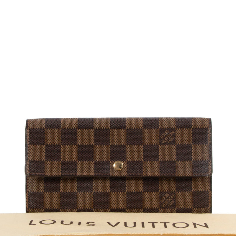 Buy online authentic second hand Louis Vuitton 2004 Vintage Damier Ebene Sarah Long Wallet in very good condition at Labellov in Antwerp