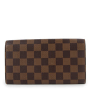 Buy online authentic second hand Louis Vuitton 2004 Vintage Damier Ebene Sarah Long Wallet in very good condition at Labellov in Antwerp