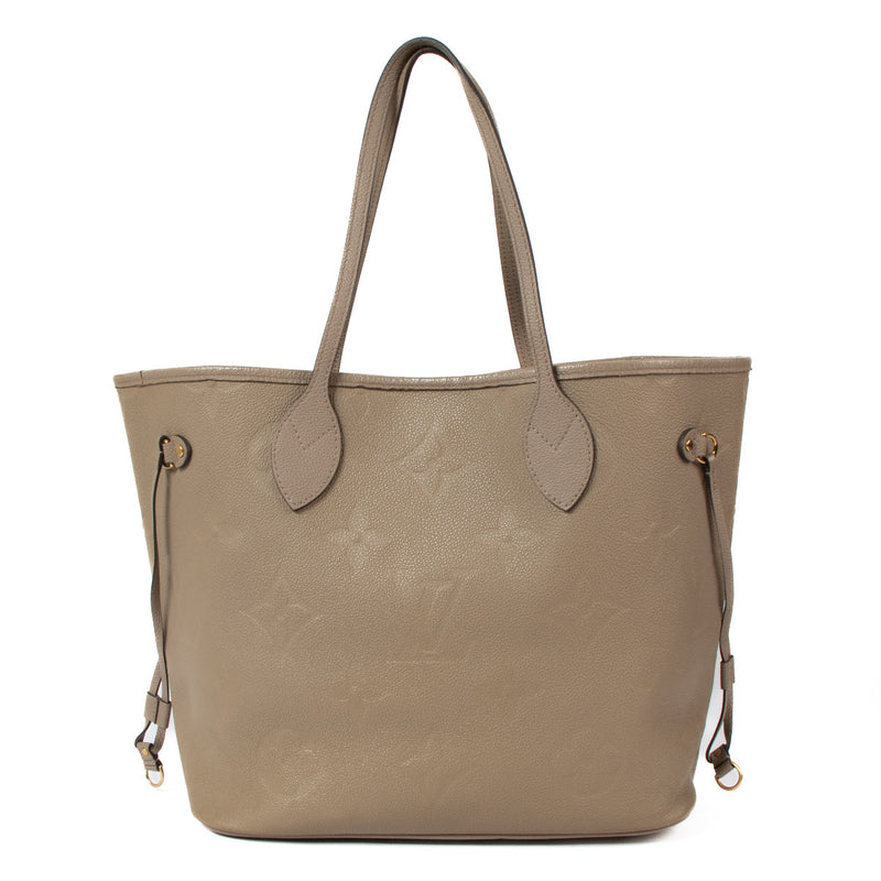 The Louis Vuitton Tourterelle Monogram Empreinte Neverfull MM is the perfect blend of sophistication, practicality, and timeless design. Crafted in the iconic Monogram Empreinte leather in a soft tourterelle (grey) hue, this bag is both chic and durable,