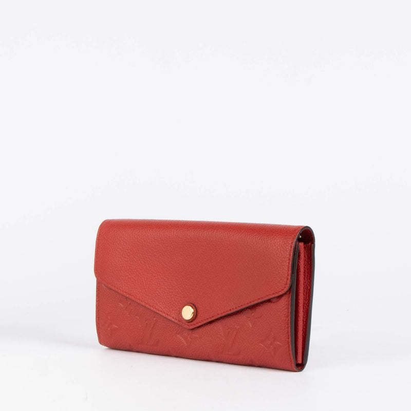 Authentic pre-loved Louis Vuitton Red Monogram Empreinte Leather Sarah Wallet on Labellov.com