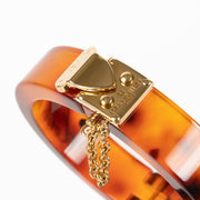 Shop this authentic Louis Vuitton Lock Me Tortoise Brown Resin Bangle Bracelet pre-loved on Labellov.com 