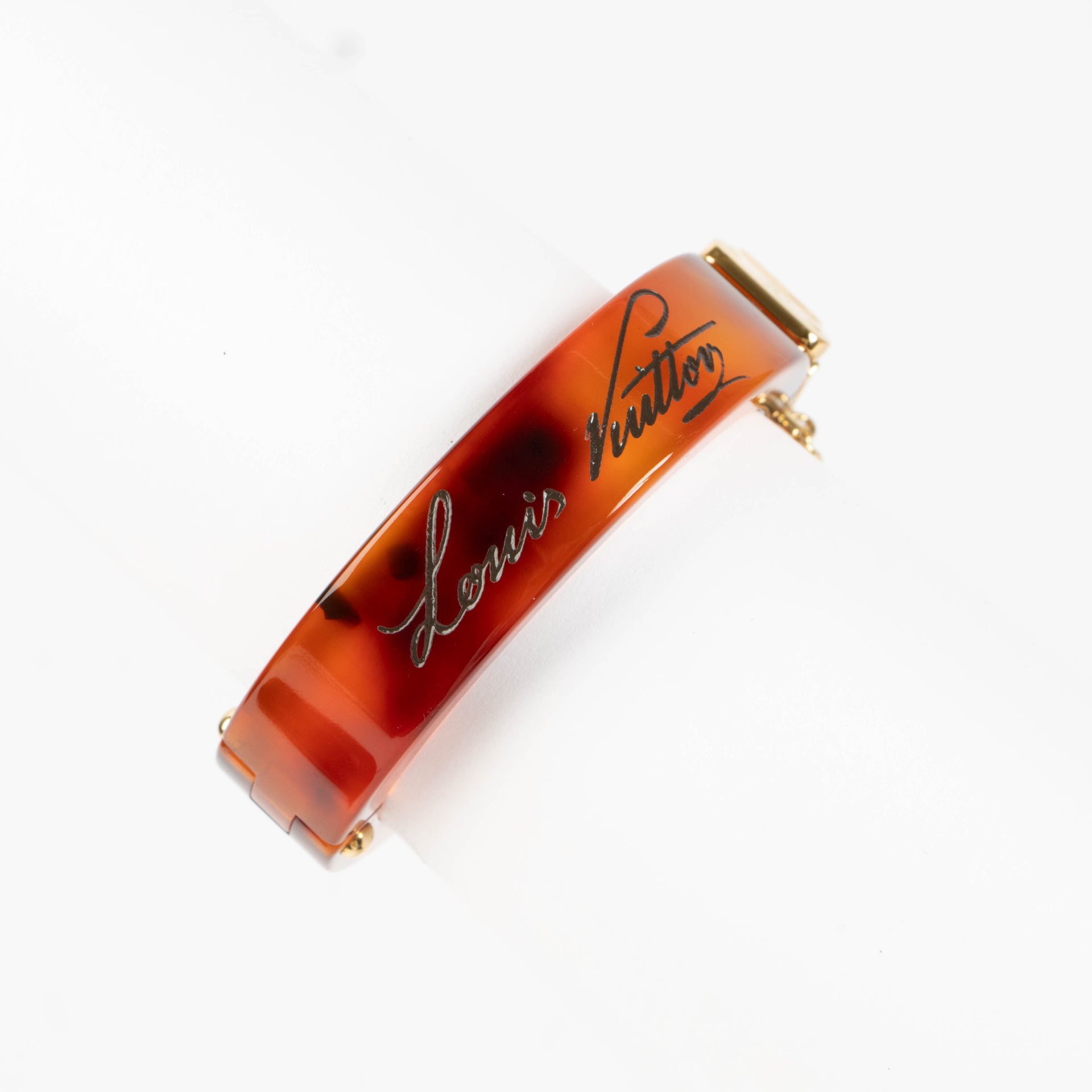 Shop this authentic Louis Vuitton Lock Me Tortoise Brown Resin Bangle Bracelet pre-loved on Labellov.com 