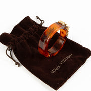 Shop this authentic Louis Vuitton Lock Me Tortoise Brown Resin Bangle Bracelet pre-loved on Labellov.com 