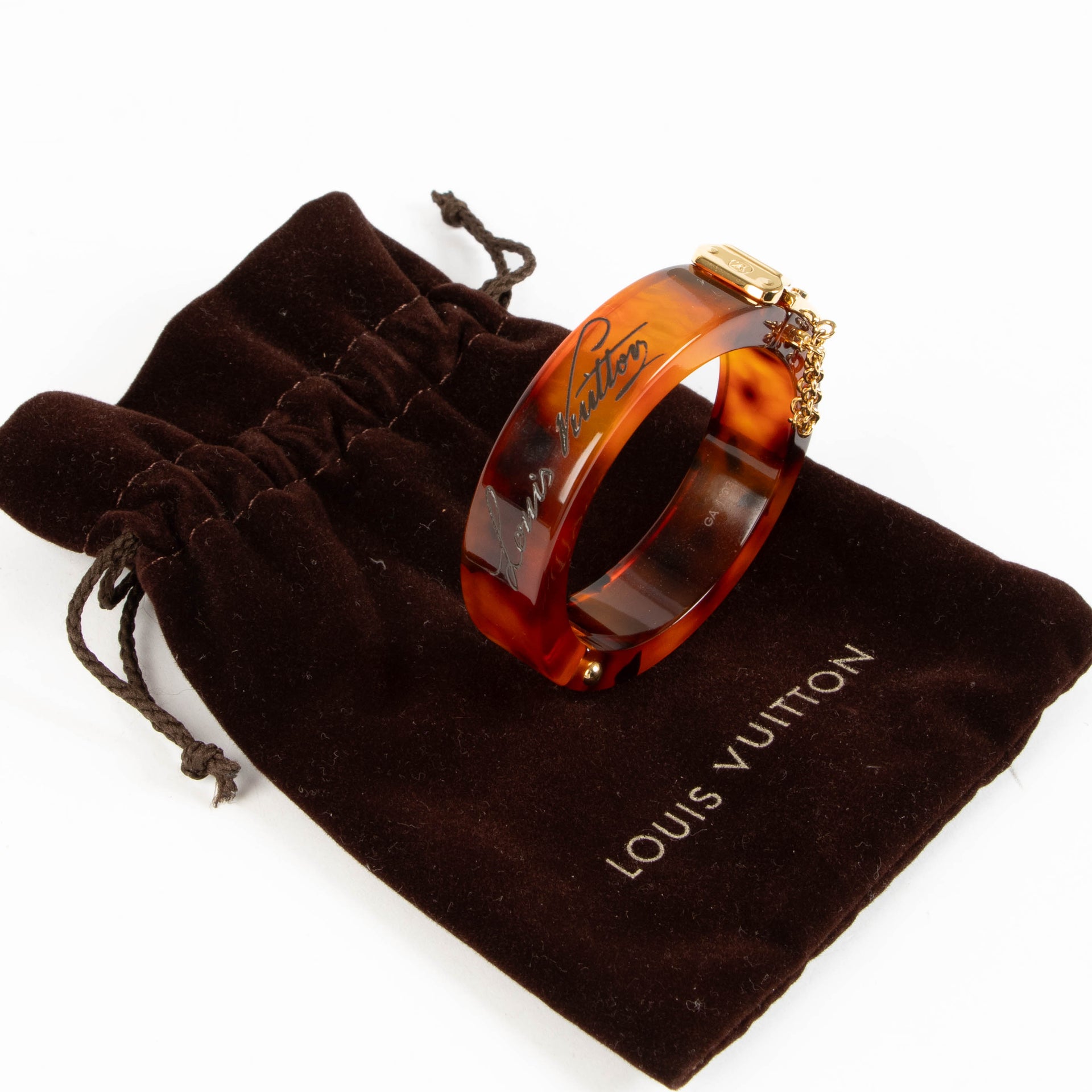 Shop this authentic Louis Vuitton Lock Me Tortoise Brown Resin Bangle Bracelet pre-loved on Labellov.com 