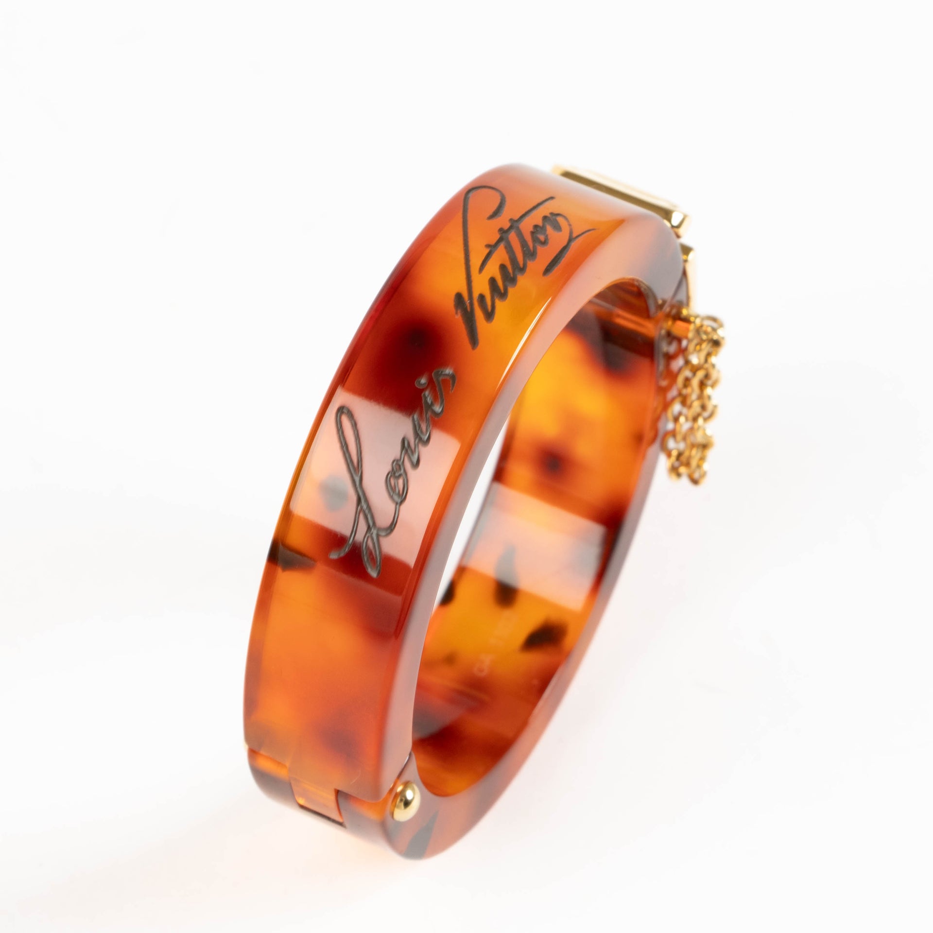 Shop this authentic Louis Vuitton Lock Me Tortoise Brown Resin Bangle Bracelet pre-loved on Labellov.com 