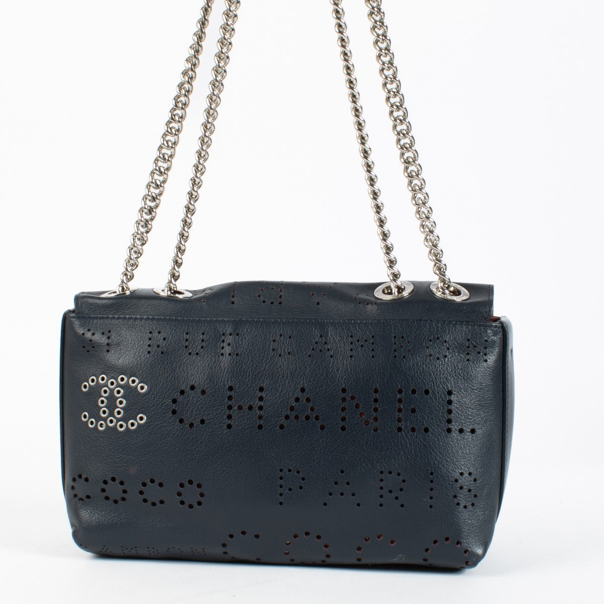 Chanel Blue Eyelet Flap Bag with silver chain strap and pink suede interior at Labellov.com