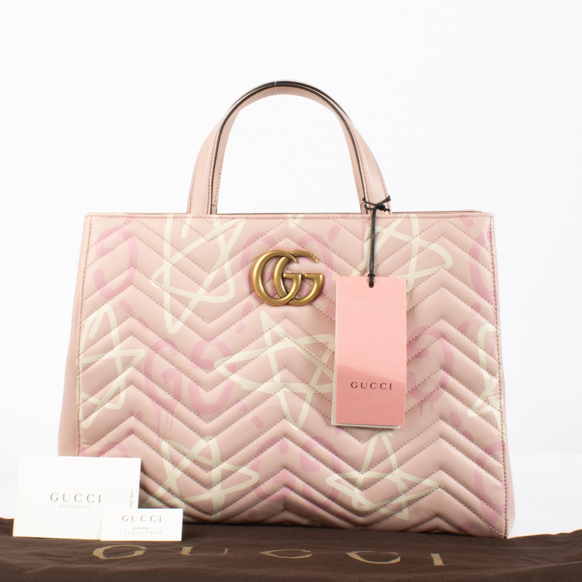 Shop the authentic Gucci GG Marmont Graffiti Matelassé Tote in pink leather at Labellov.com.