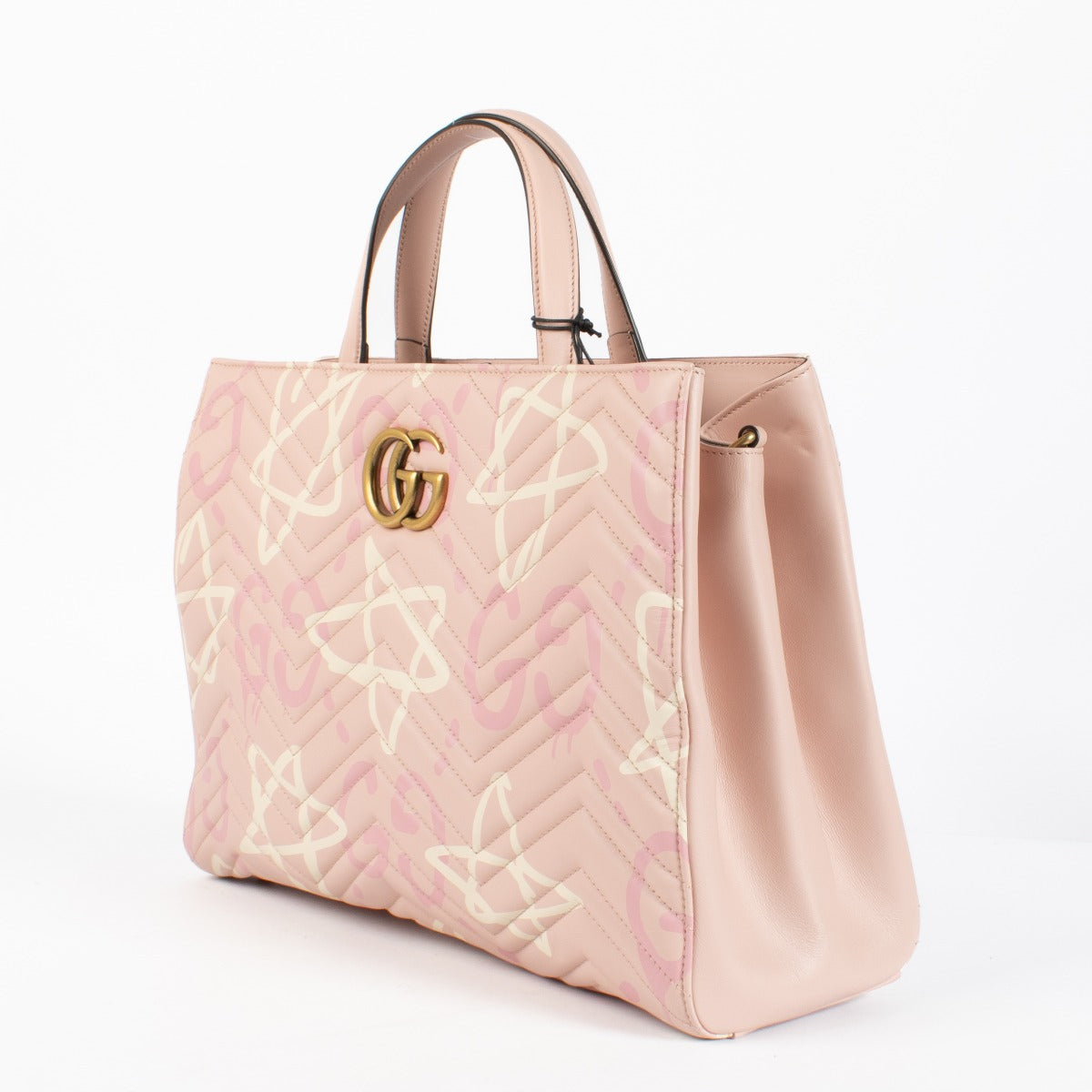 Shop the authentic Gucci GG Marmont Graffiti Matelassé Tote in pink leather at Labellov.com.