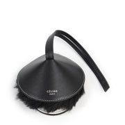 Céline Black and White Fur Bag Charm. Authentieke Céliné accessoires bij LabelLOV Antwerpen. Authentique luxury en ligne webshop LabelLOV. Authentic Céline accessories at LabelLOV Antwerp.