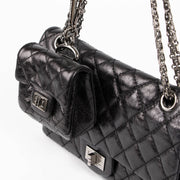 Shop this authentic Chanel Black Aged Calfskin Medium 2.55 Reissue Bag with Micro Pouch pre-loved on Labellov.com 