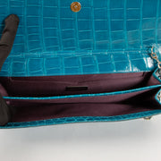 Shop this authentic Judith Leiber Blue Shiny Alligator Crystal Criket Clutch Pre-Loved on Labellov.com