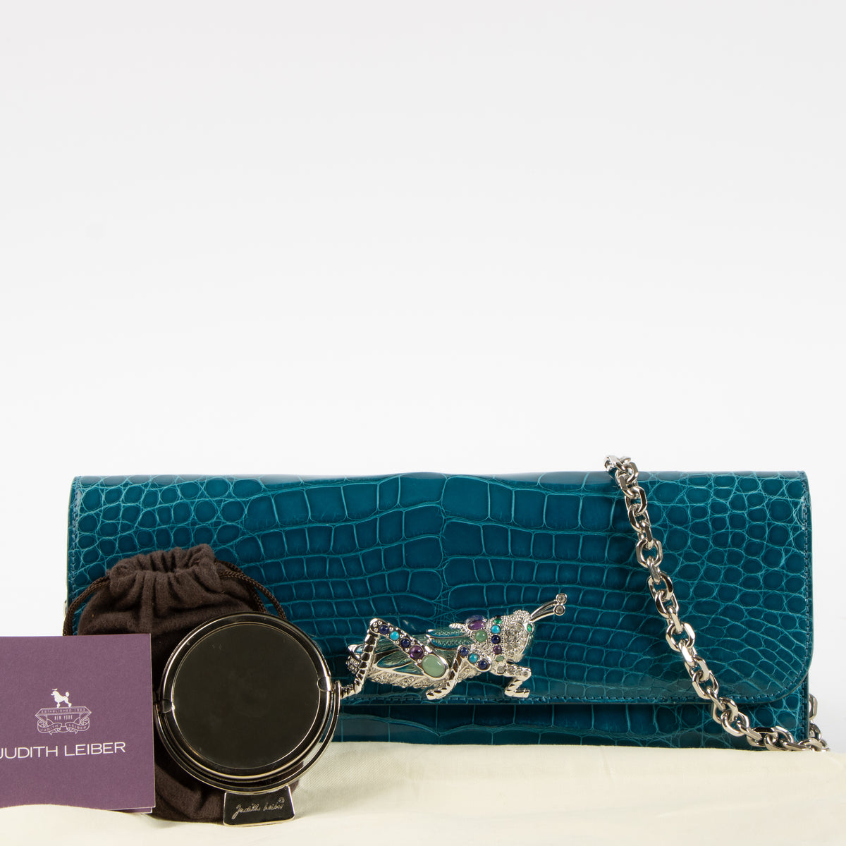 Shop this authentic Judith Leiber Blue Shiny Alligator Crystal Criket Clutch Pre-Loved on Labellov.com