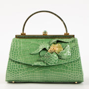 Shop this authentic Judith Leiber Green Shiny Alligator Frame Clutch Pre-Loved on Labellov.com