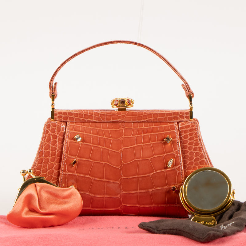 Shop this authentic Judith Leiber Old Rose Shiny Alligator Frame Clutch Pre-Loved on Labellov.com