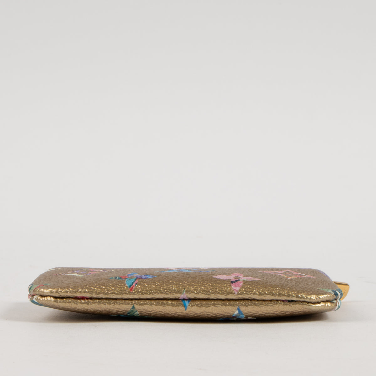 Shop this authentic Louis Vuitton Gold Monogram Garden Key Pouch pre-loved on Labellov.com