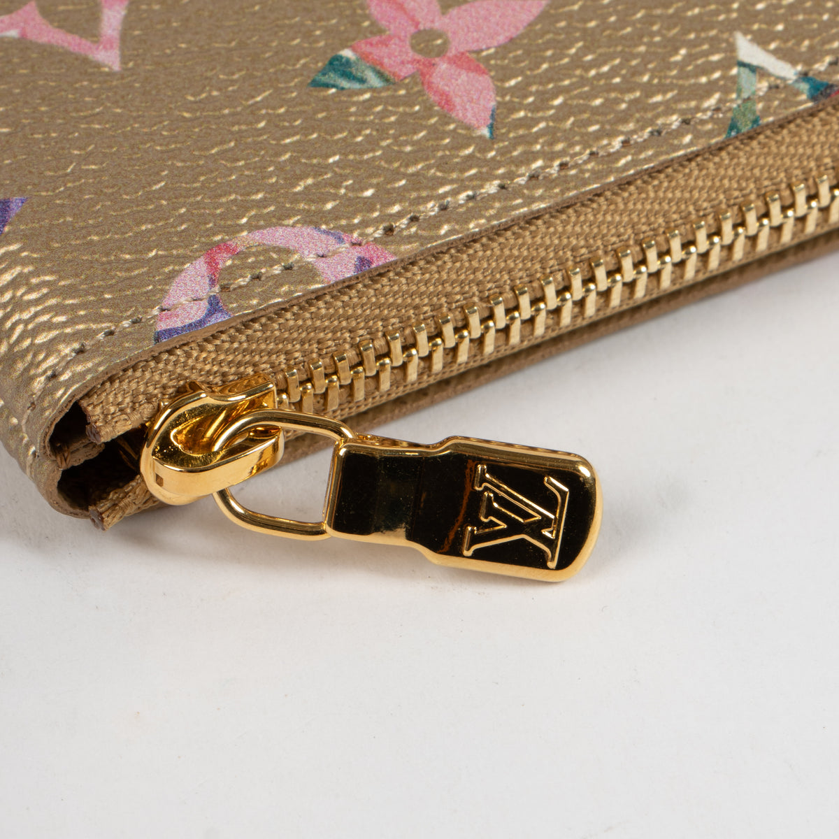Shop this authentic Louis Vuitton Gold Monogram Garden Key Pouch pre-loved on Labellov.com