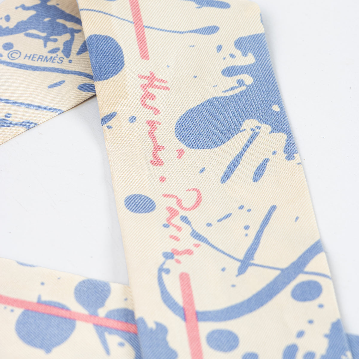 Shop this authentic Hermes Blue Paint Splatter Twilly Scarf pre-loved on Labellov.com