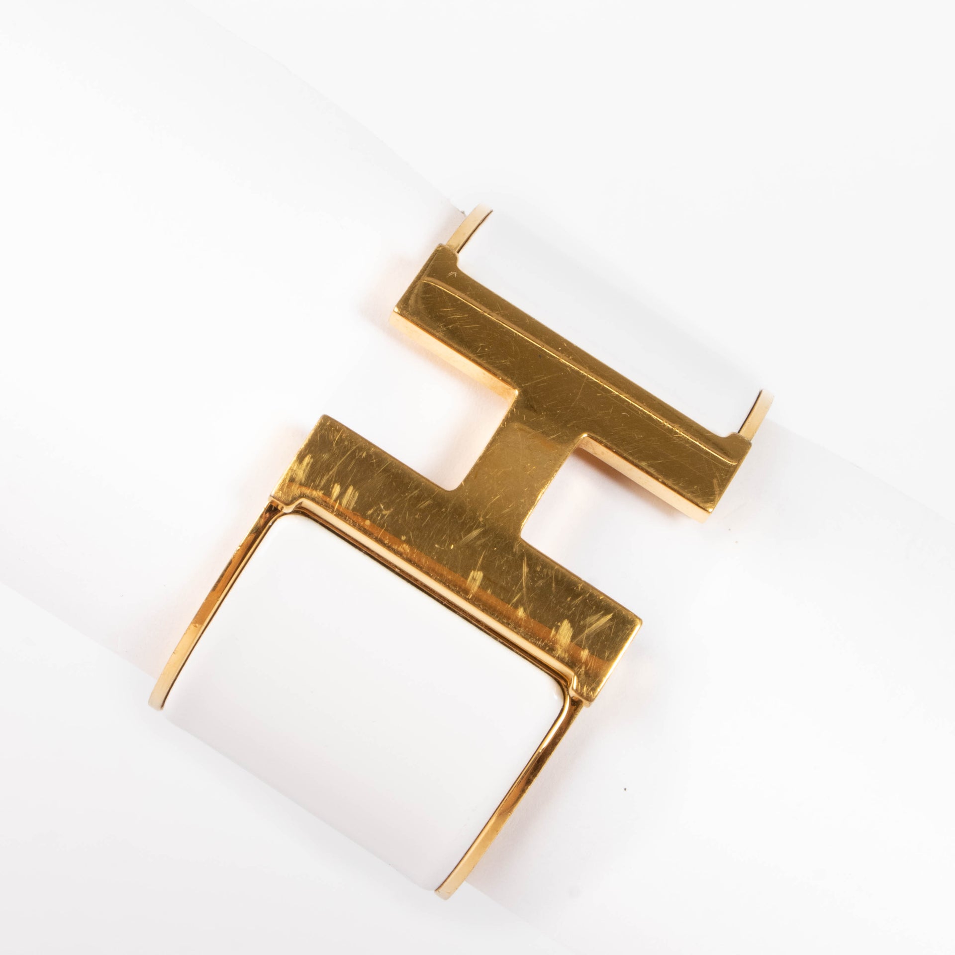 shop this authentic Hermes White/Gold Extra Wide Clic H Bracelet pre-loved on Labellov.com