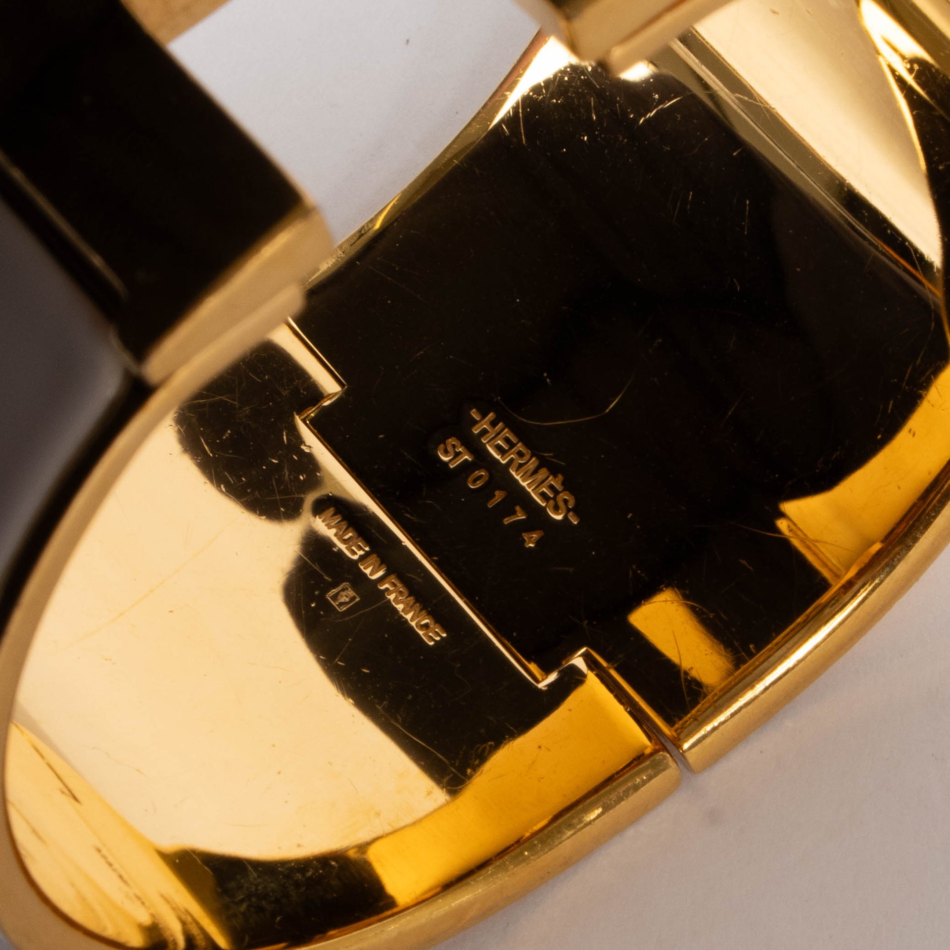 shop this authentic Hermes White/Gold Extra Wide Clic H Bracelet pre-loved on Labellov.com