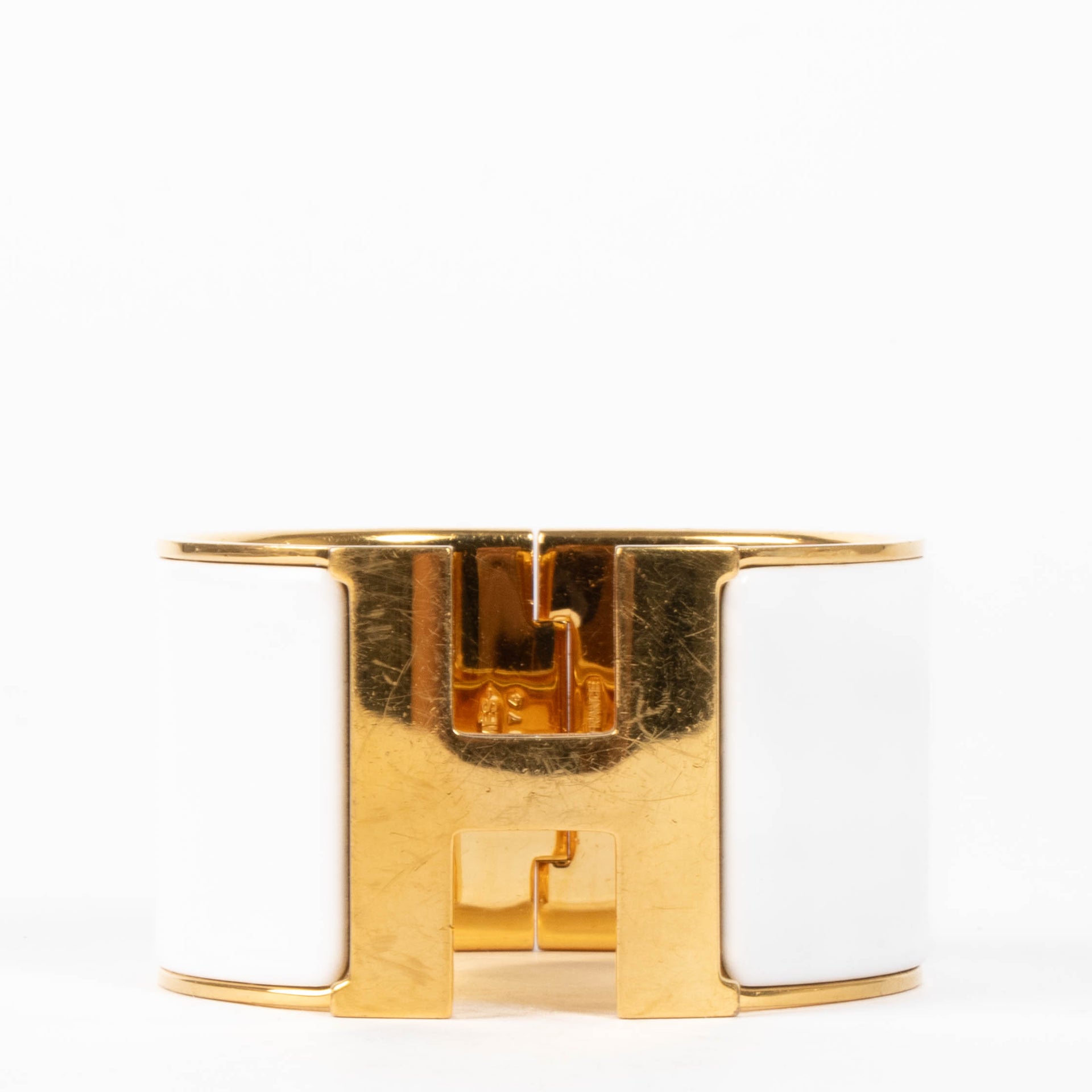 shop this authentic Hermes White/Gold Extra Wide Clic H Bracelet pre-loved on Labellov.com