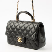Shop this authentic Chanel Black Lambskin Mini Classic Bag with Handle pre-loved on Labellov.com