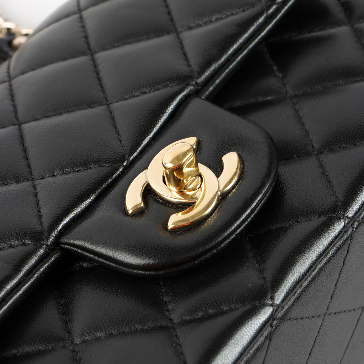 Shop this authentic Chanel Black Lambskin Mini Classic Bag with Handle pre-loved on Labellov.com
