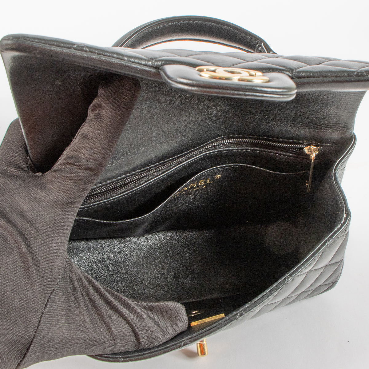 Shop this authentic Chanel Black Lambskin Mini Classic Bag with Handle pre-loved on Labellov.com