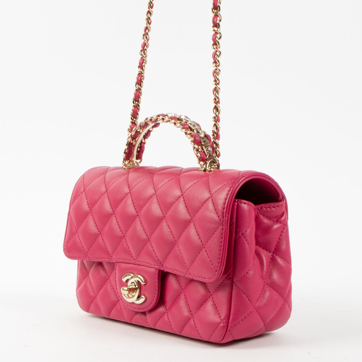 Shop this authentic Chanel Pink Lambskin Mini Classic Bag with Crystal Embellished Handle pre-loved on Labellov.com 