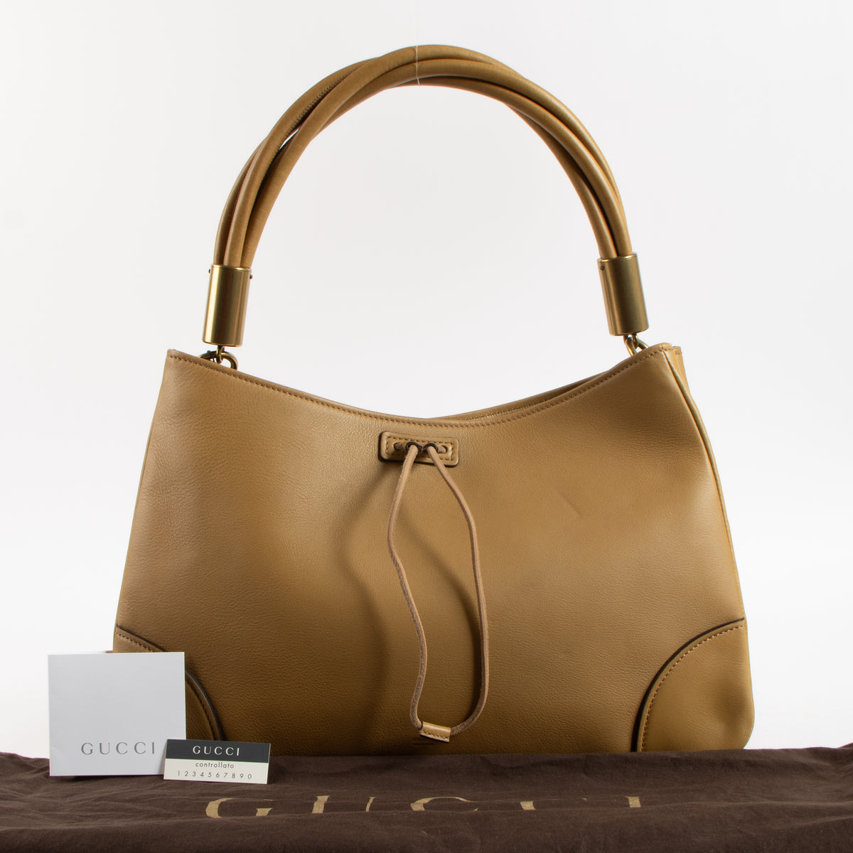Shop this authentic Gucci Beige Leather Drawstring Bag pre-loved on Labellov.com