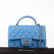 Shop this authentic Chanel Blue Lambskin Mini Flap Bag with Handle pre-loved on Labellov.com